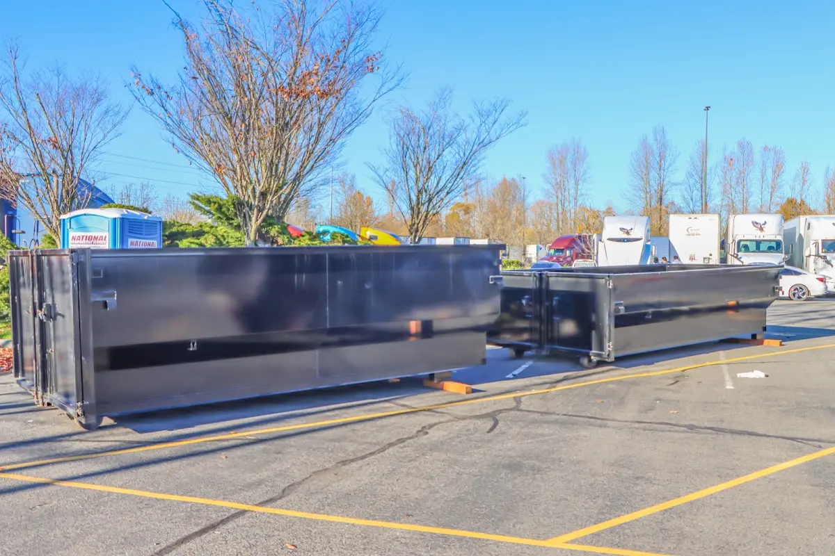 Professional dumpster rental service with roll-off container on residential driveway in New Haven